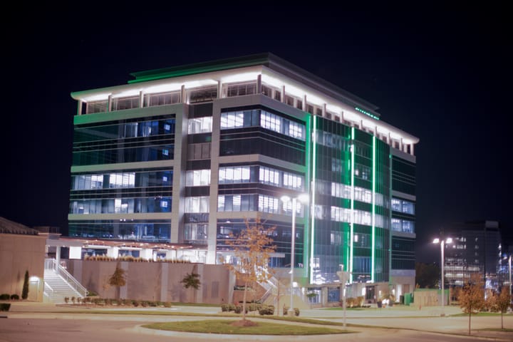 A brightly illuminated office building at night