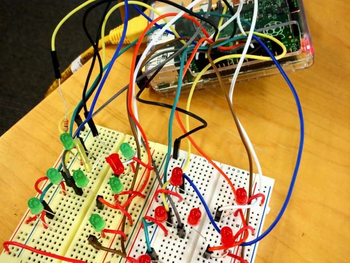 Red and green LEDs wired on breadboards to a Raspberry Pi